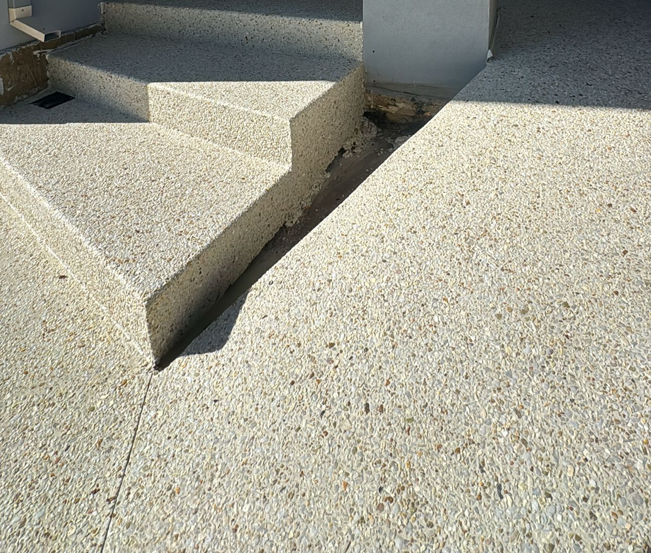 Exposed aggregate concrete stairs and ramp in coral mix