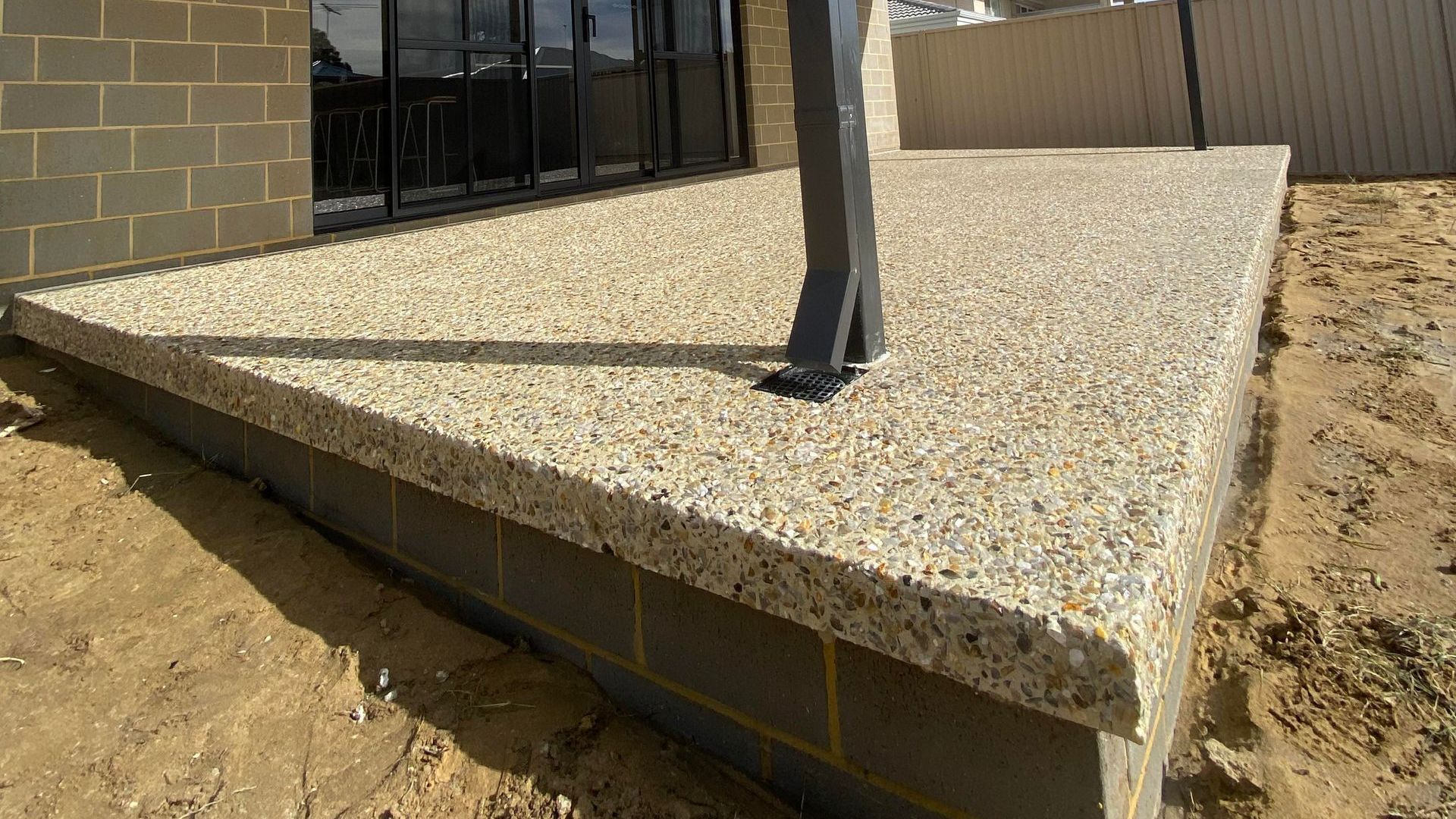 Decorative concrete alfresco floor with over hang feature Decorative concrete alfresco floor with over hang feature