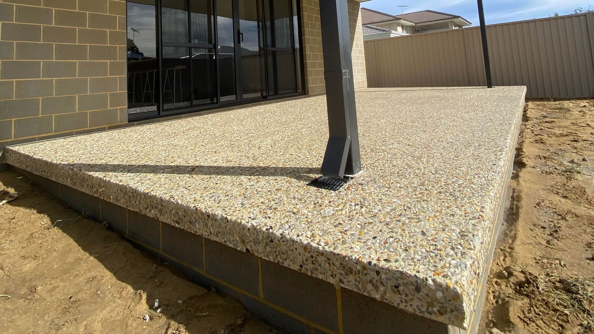 Exposed Aggregate Patio raised with Seamless Edging