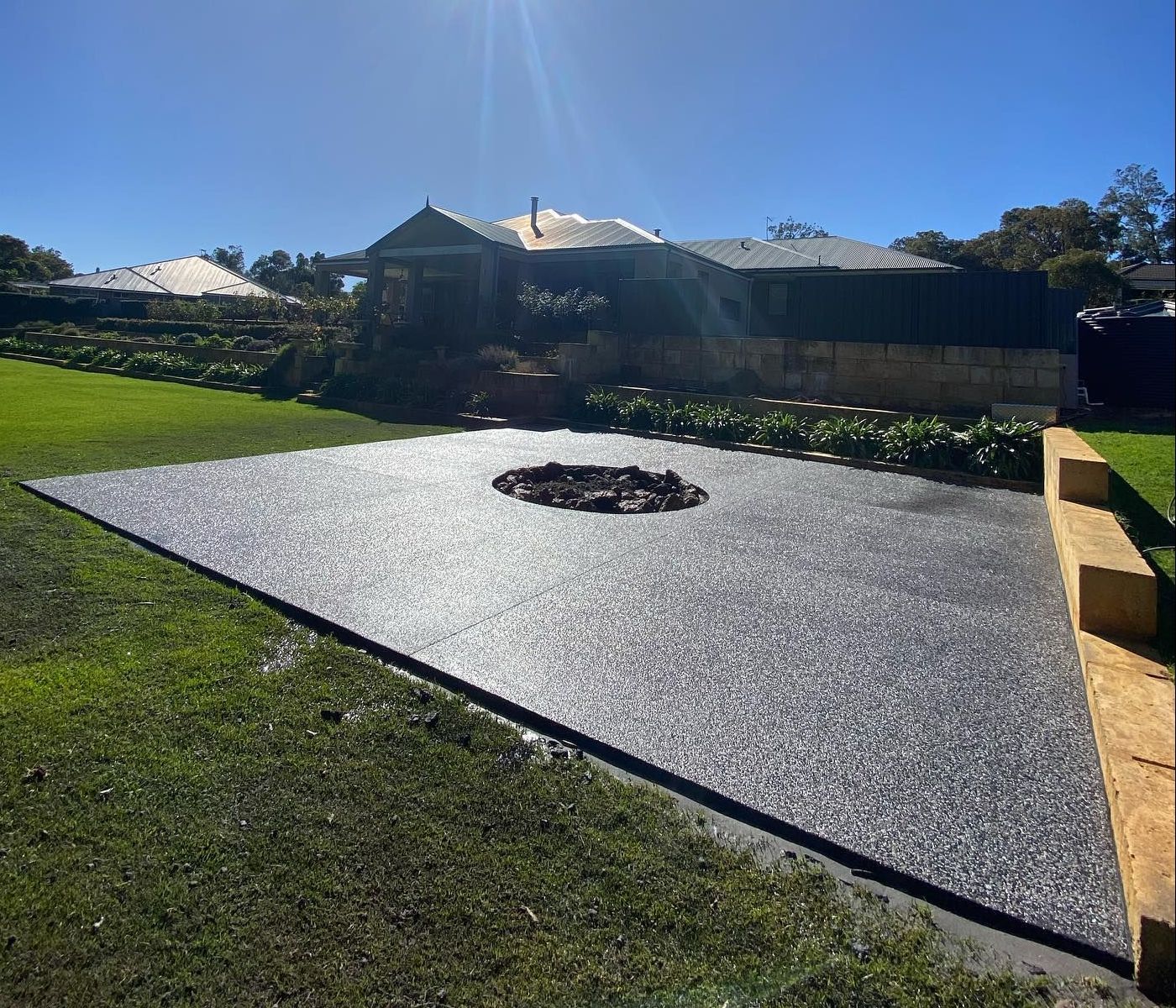 Concrete fire pit in Perth property's backyard