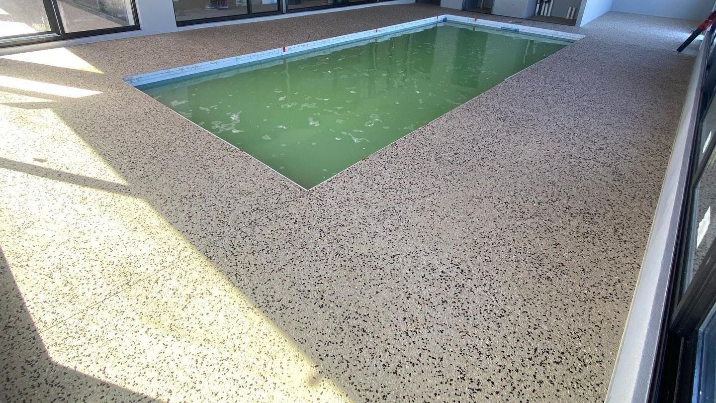 indoor honed concrete pool area and surrounds.