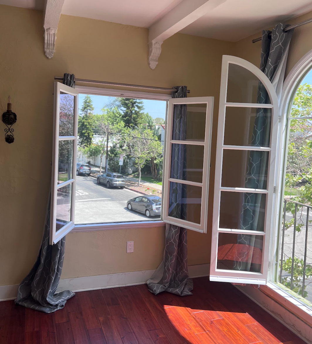 Exterior View of restored arched wood window with original trim preserved