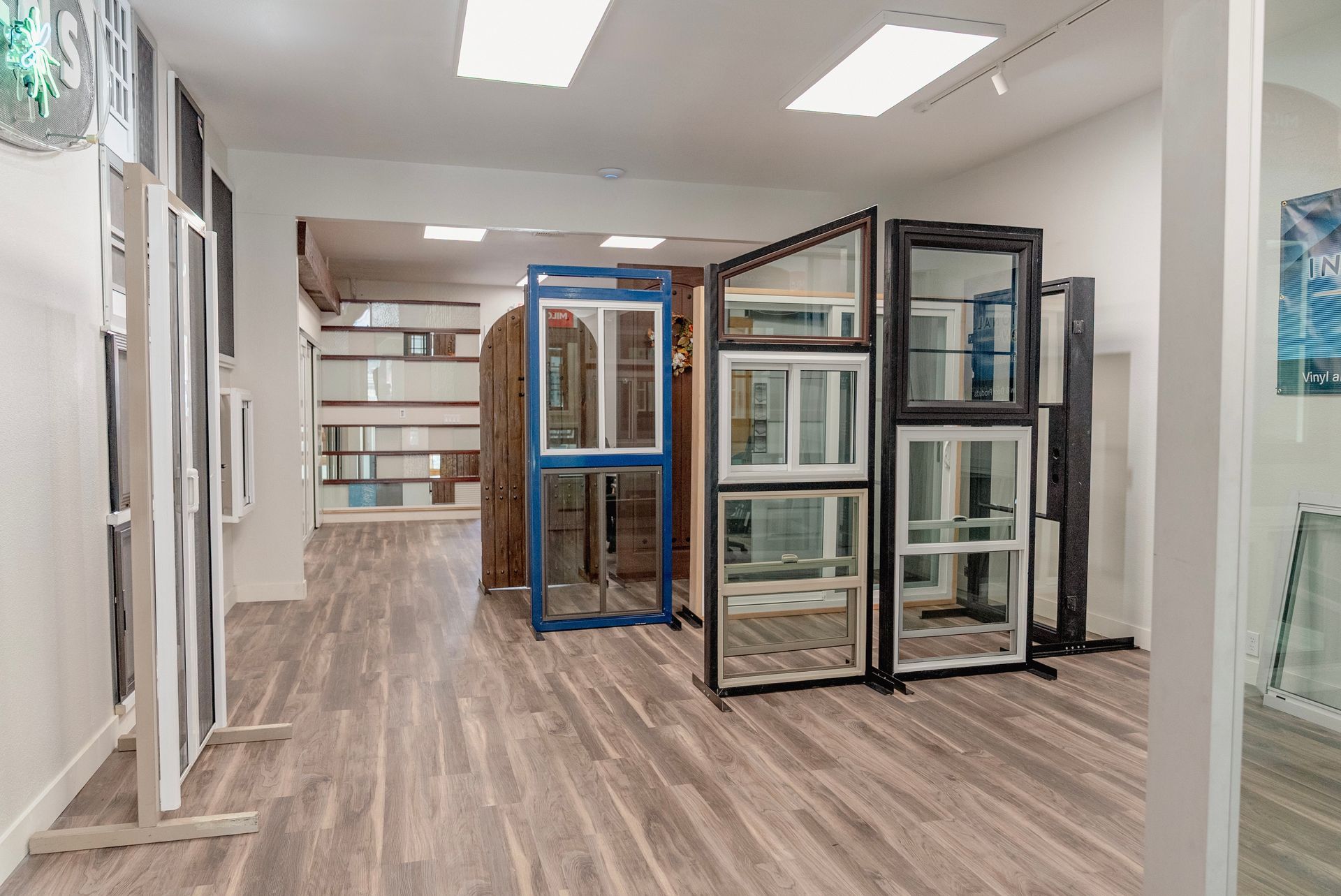 Showroom with window displays; various styles and colors against wood flooring.