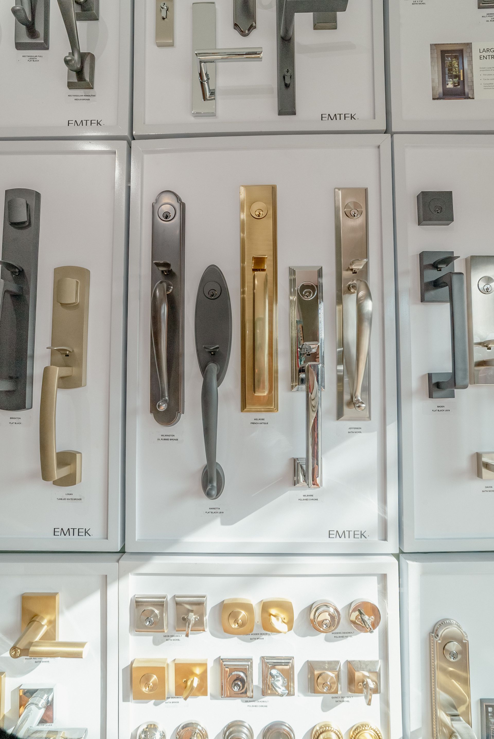 Display of various door handles and hardware on a white background.