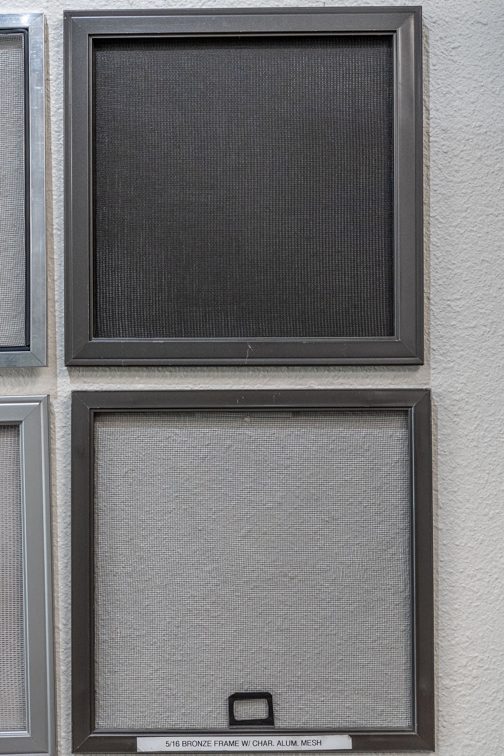 Two rectangular air filters, one dark and one light gray, in metal frames.