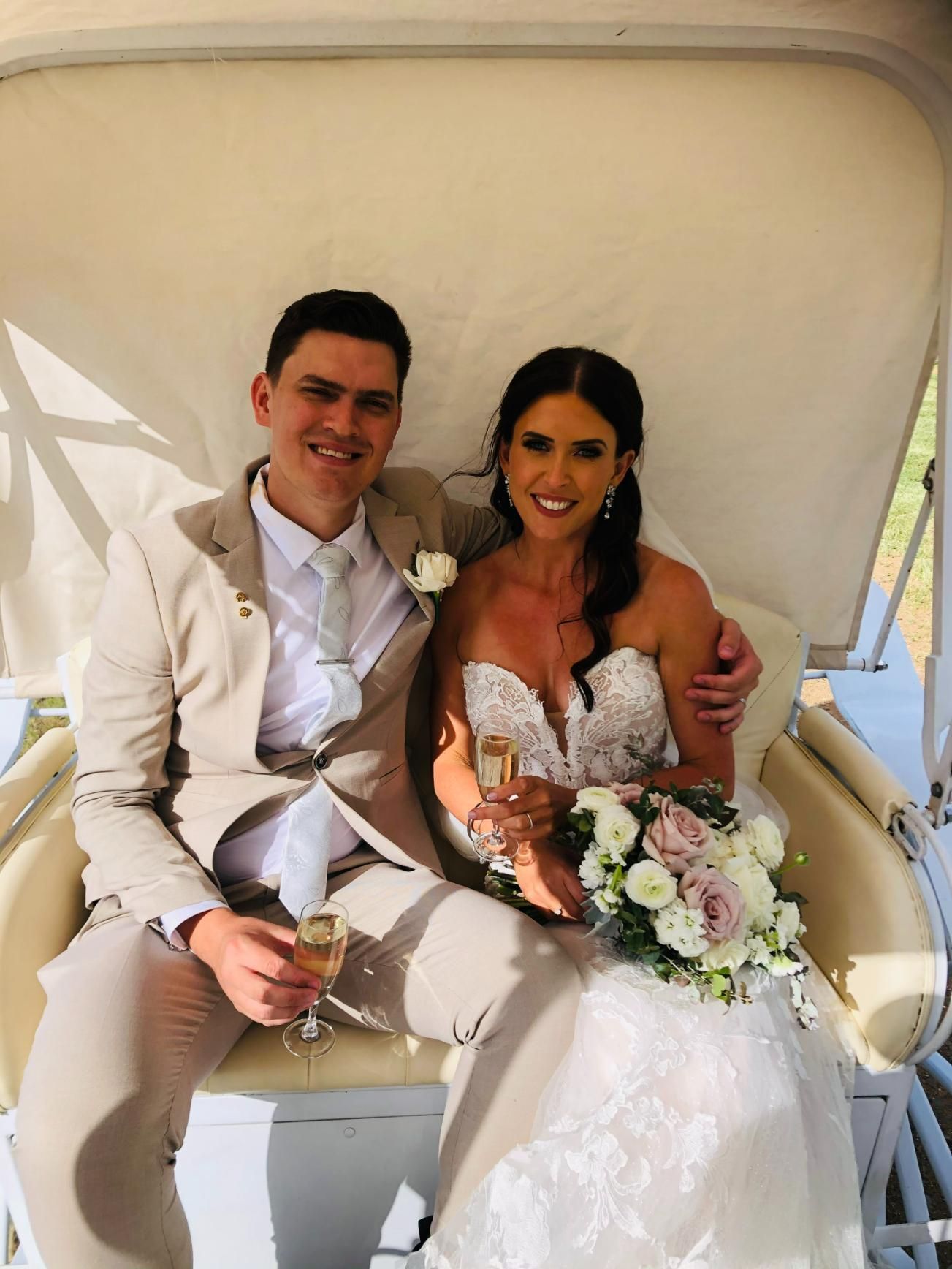A Bride and Groom Are Sitting in a Carriage Holding Champagne — Prestige Horse Carriages in Hunter Valley, NSW