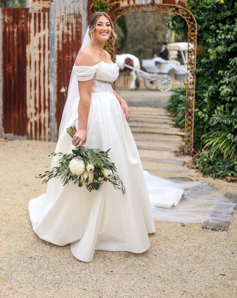 The Bride is Wearing a White Wedding Dress — Prestige Horse Carriages in Central Coast, NSW
