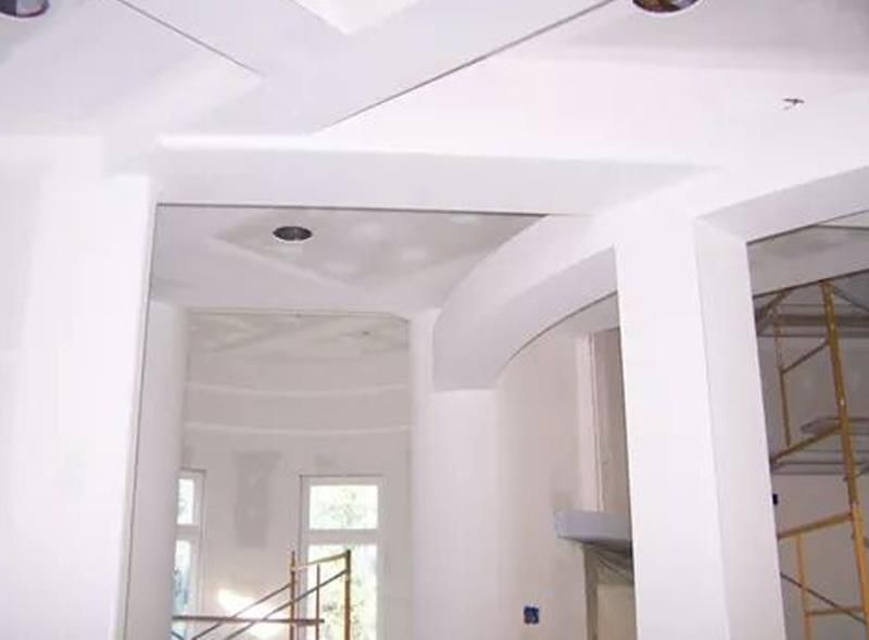 A room with white walls and scaffolding in it