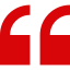 A red quote icon on a white background.