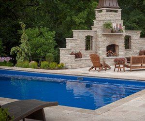 swimming pool near outdoor fireplace