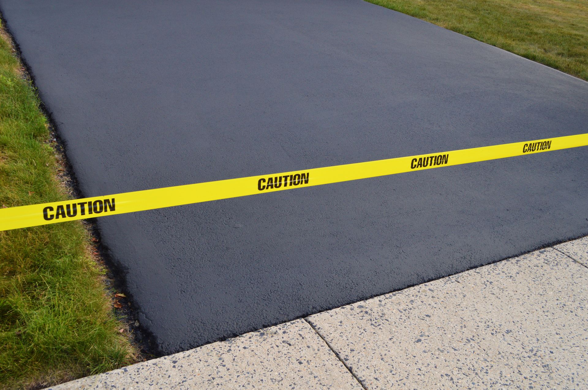 A caution tape is on the side of a road