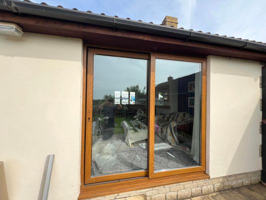 A house with a sliding glass door on the side of it.