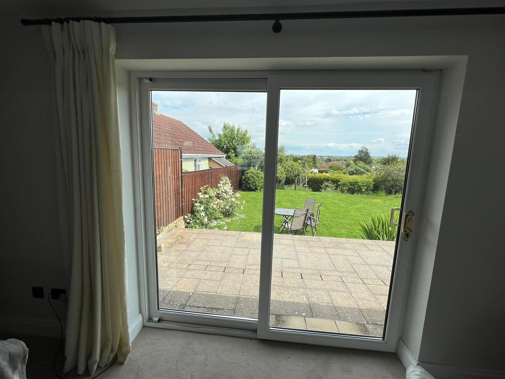 A room with a sliding glass door leading to a patio.