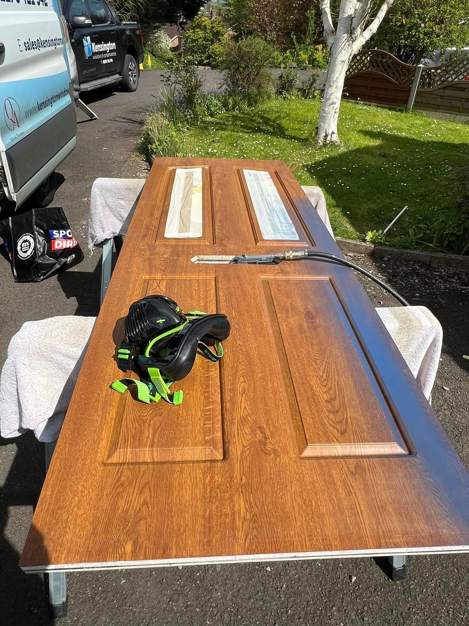 A wooden door is sitting on top of a wooden table.
