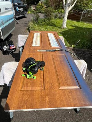 A wooden door is sitting on top of a wooden table.
