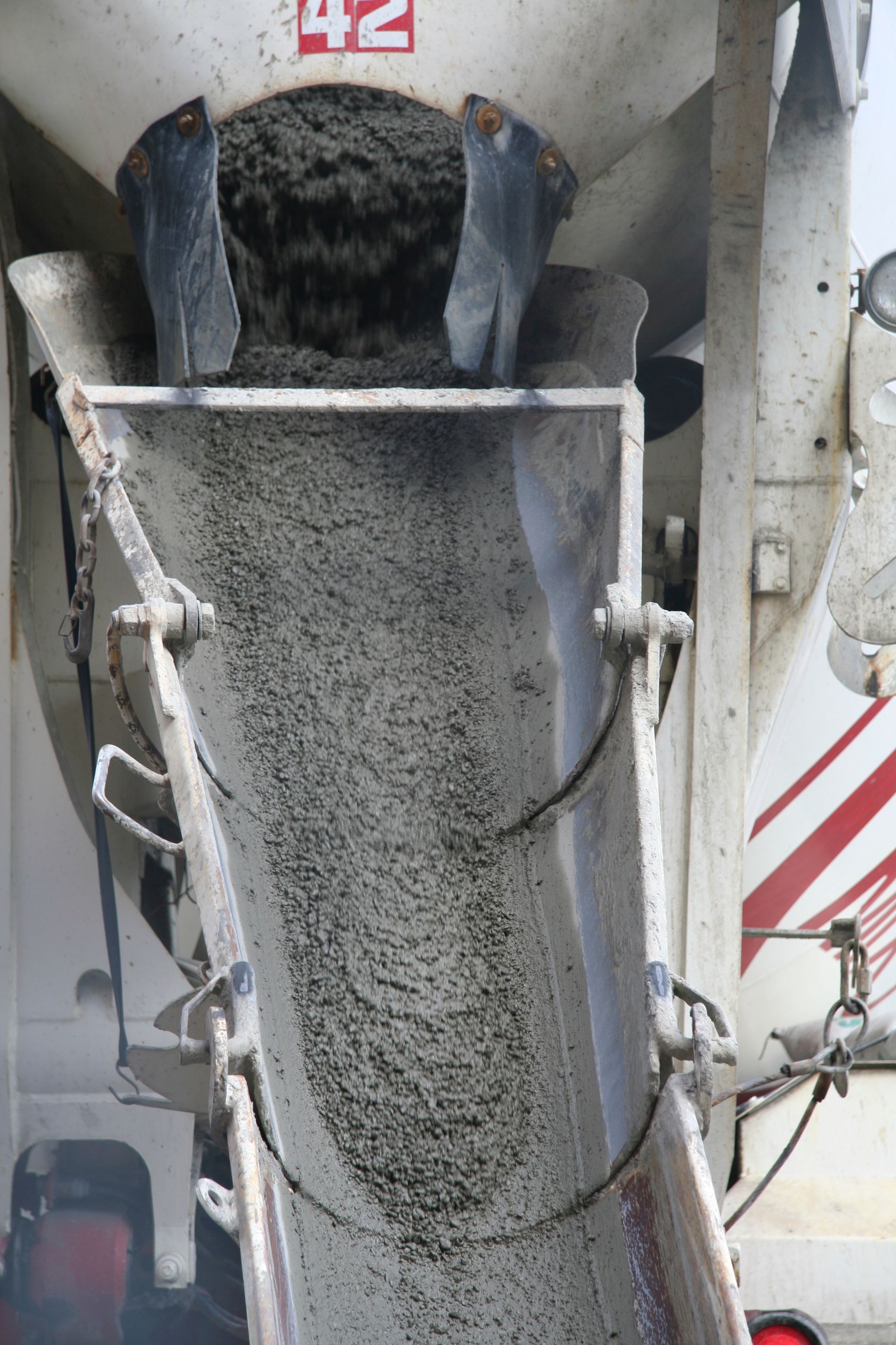A concrete mixer is pouring concrete into a truck