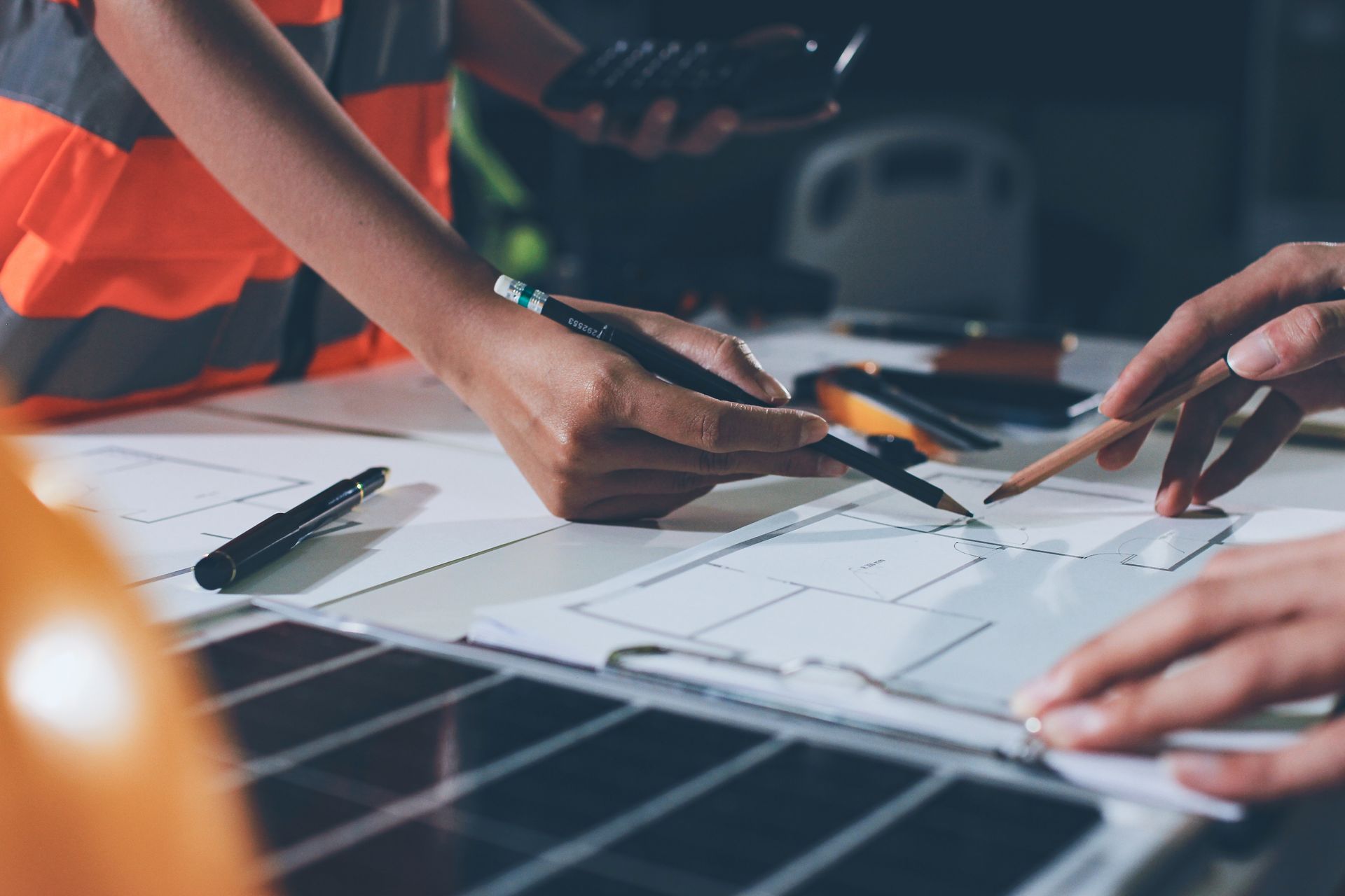 A male and female engineer are working on blueprints for a project. A male and female engineer are working on blueprints for a project.