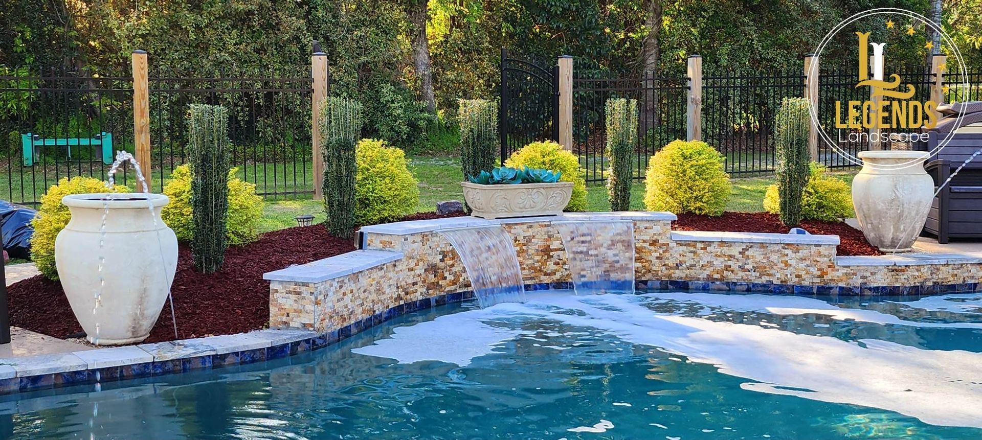 A large swimming pool with a fountain in the middle of it