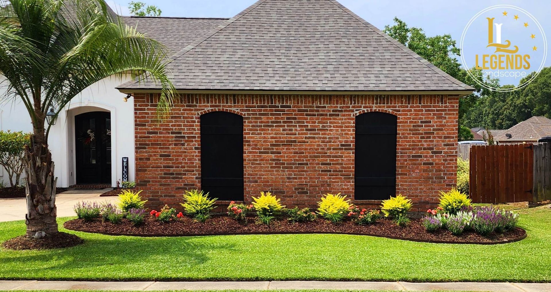 A brick house with a palm tree in front of it