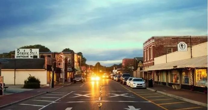 The sun is shining brightly on a small town street.