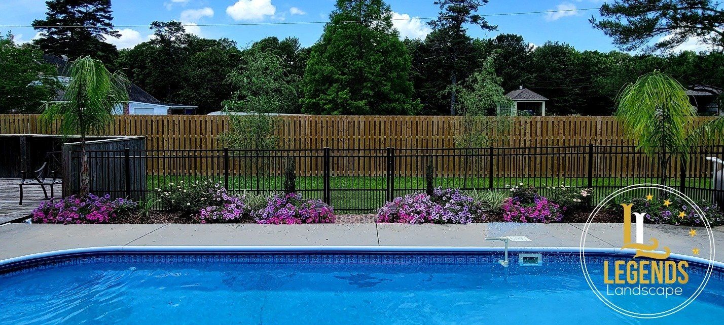 A swimming pool with a wooden fence surrounding it