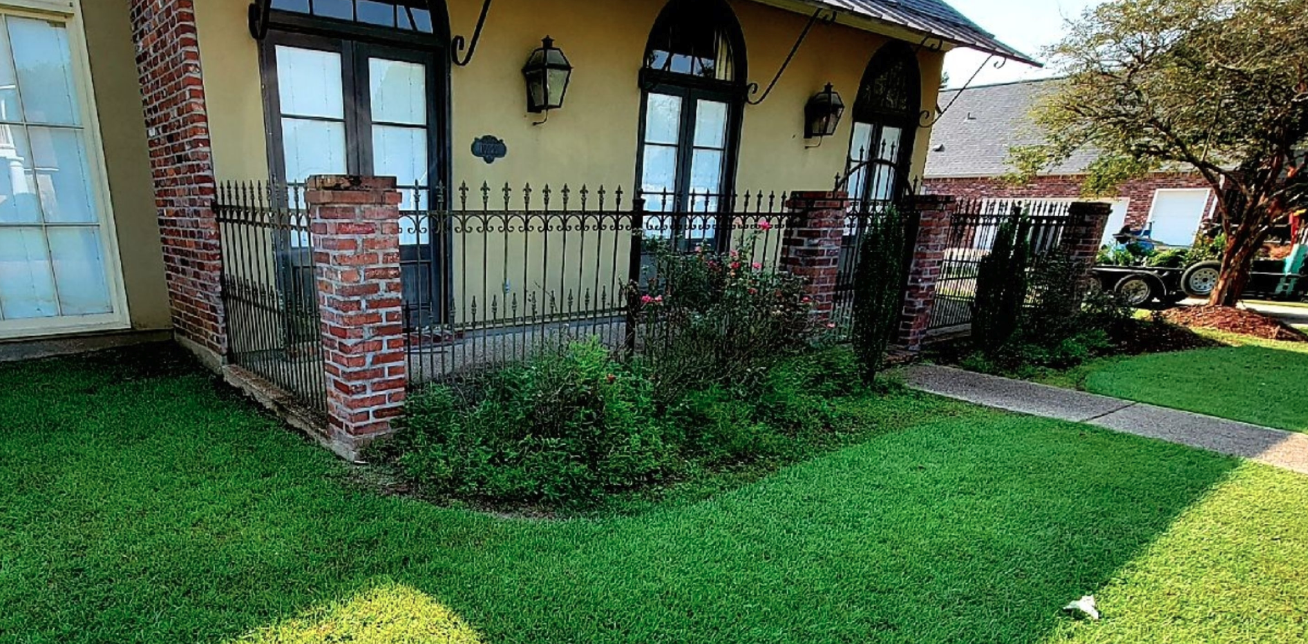 A house with a lush green lawn in front of it