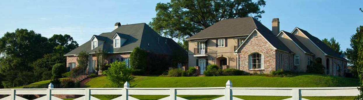 A large house with a white fence in front of it