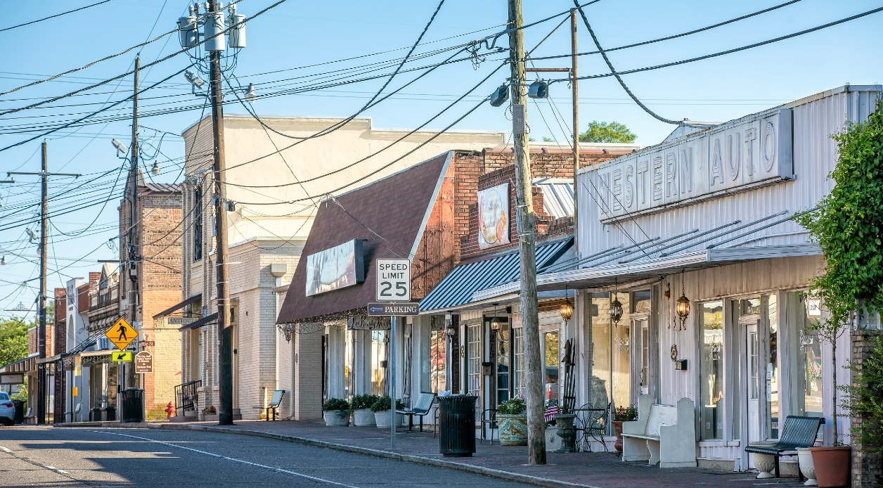 A small town street with a lot of telephone poles and buildings.