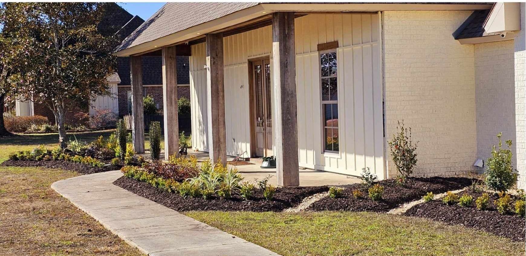 A white house with a porch and a walkway leading to it