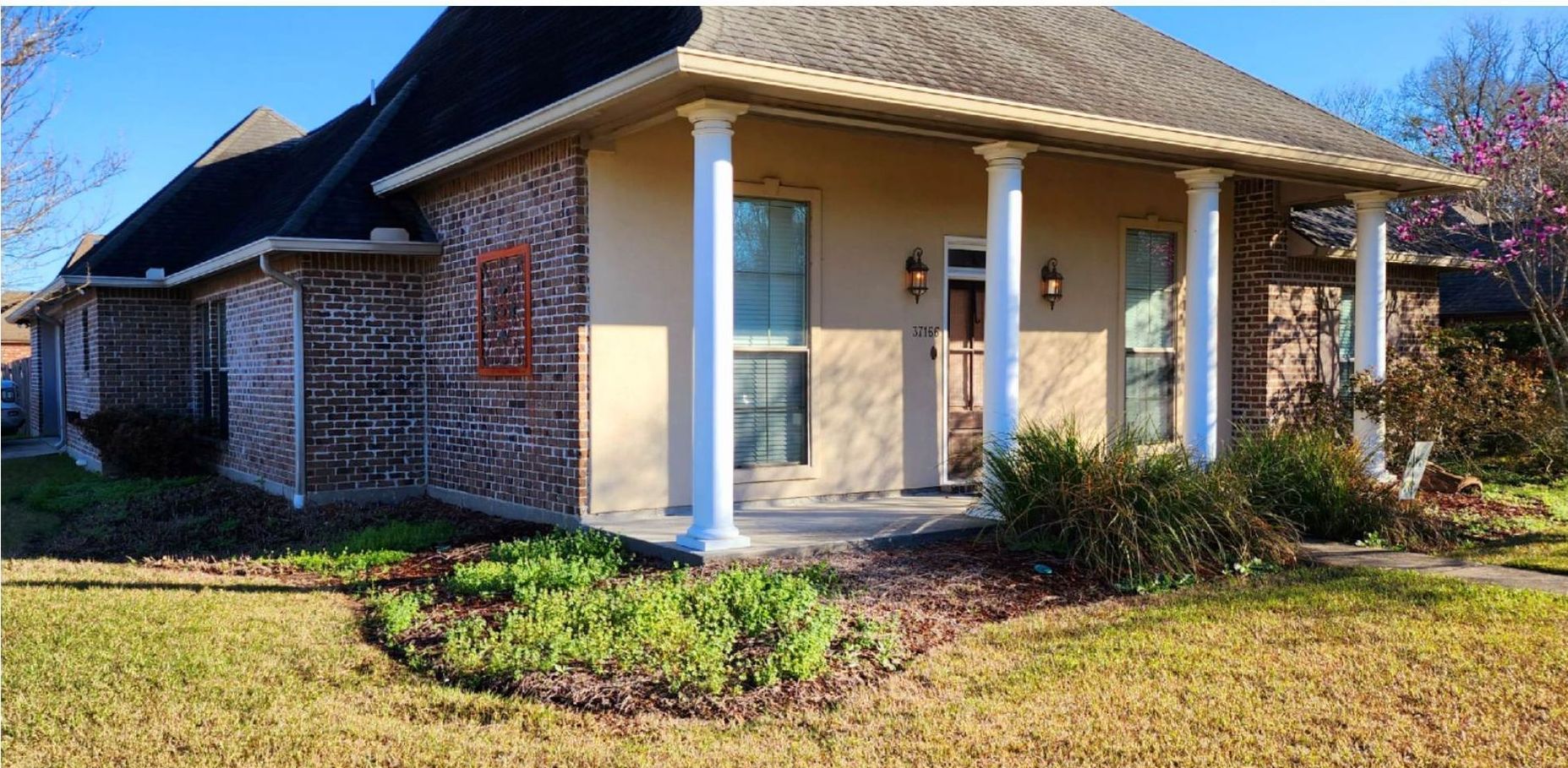 A house with a porch and columns in front of it