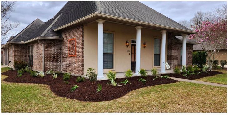 A brick house with a porch and columns in front of it
