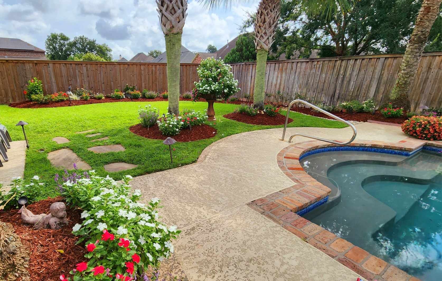 There is a swimming pool in the backyard of a house.