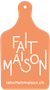 Planche à découper orange avec l'inscription « FAIT MAISON » en blanc et « labelfaitmaison.ch » en bas.