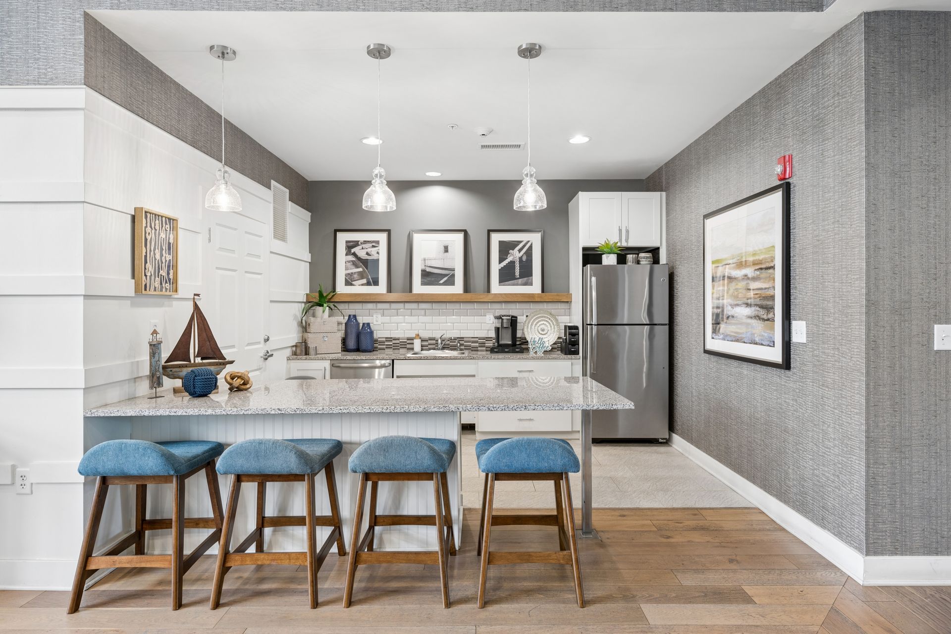The Reserve at Stoney Creek clubhouse ktichen with oversized island, modern design, and white cabinets. 