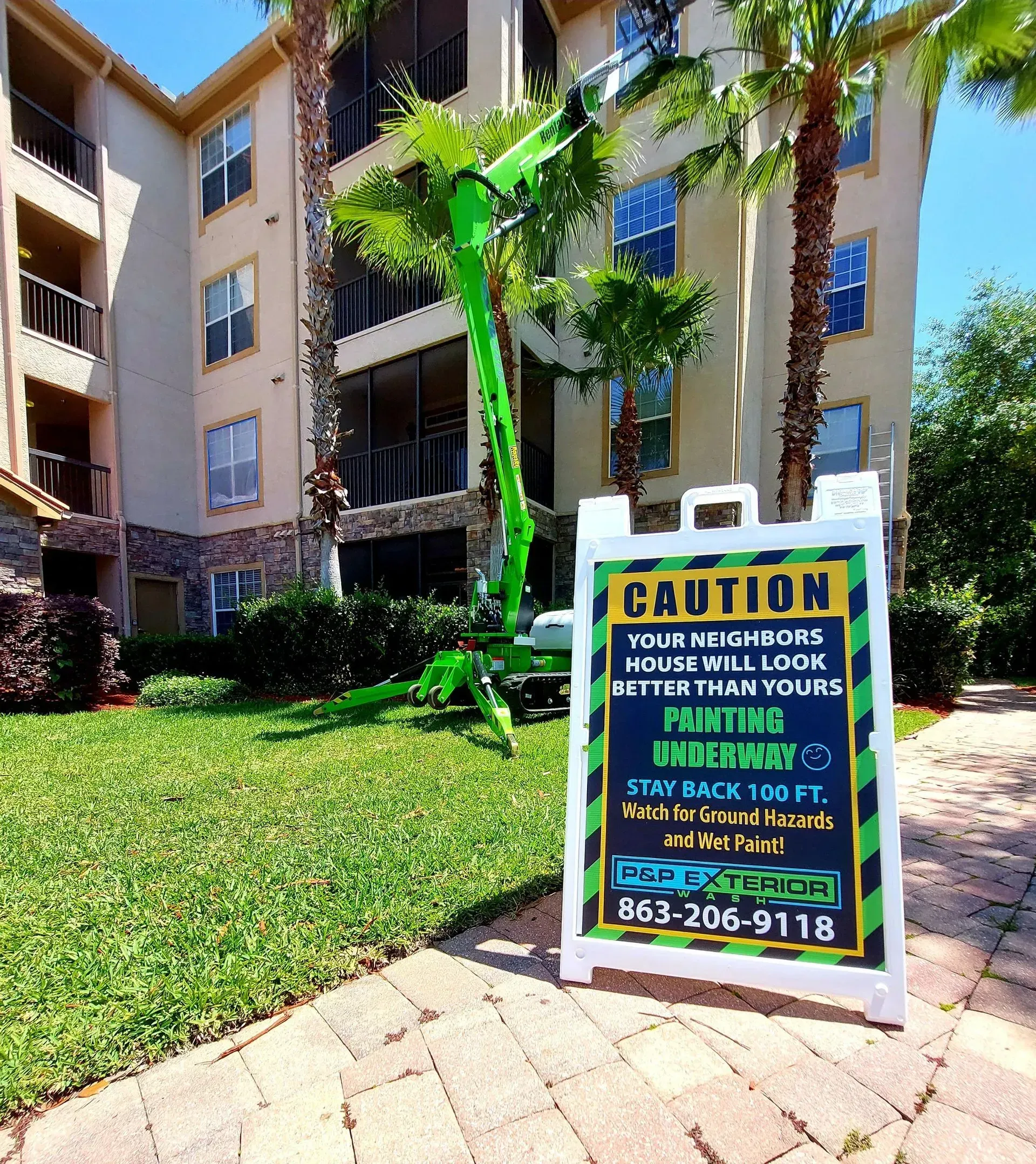 Apartment courtyard with a caution sign for house mice near a building entrance.