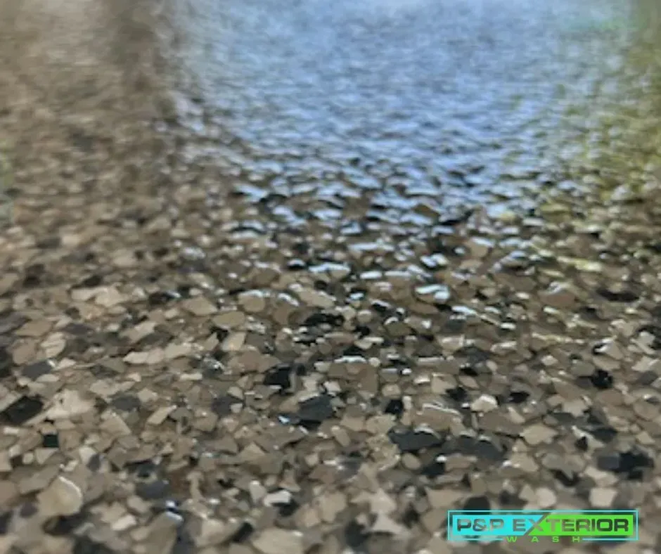 Close-up of a speckled epoxy floor with a glossy blue-gray reflection
