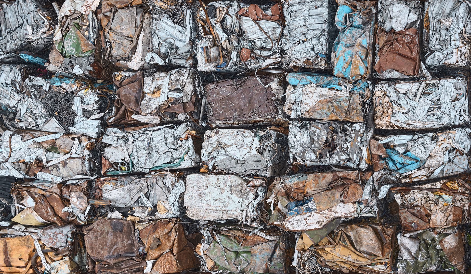 Scrap metal pressed into cubes for recycling, top view.