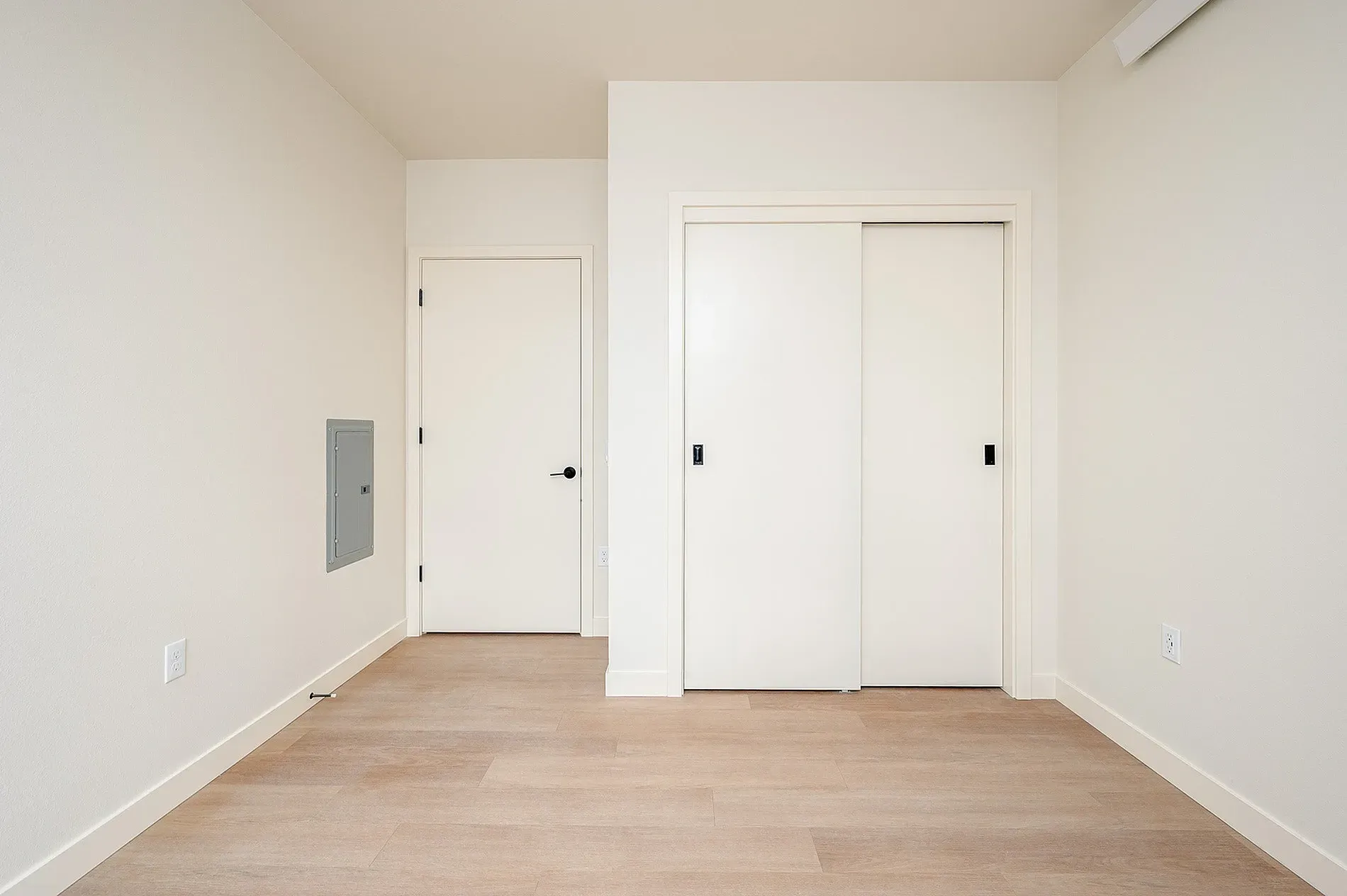 Empty room with closet and door.