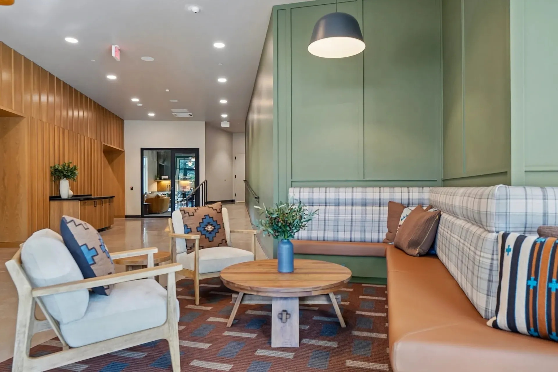 Lounge area with comfortable seating, a coffee table, and decorative pillows.