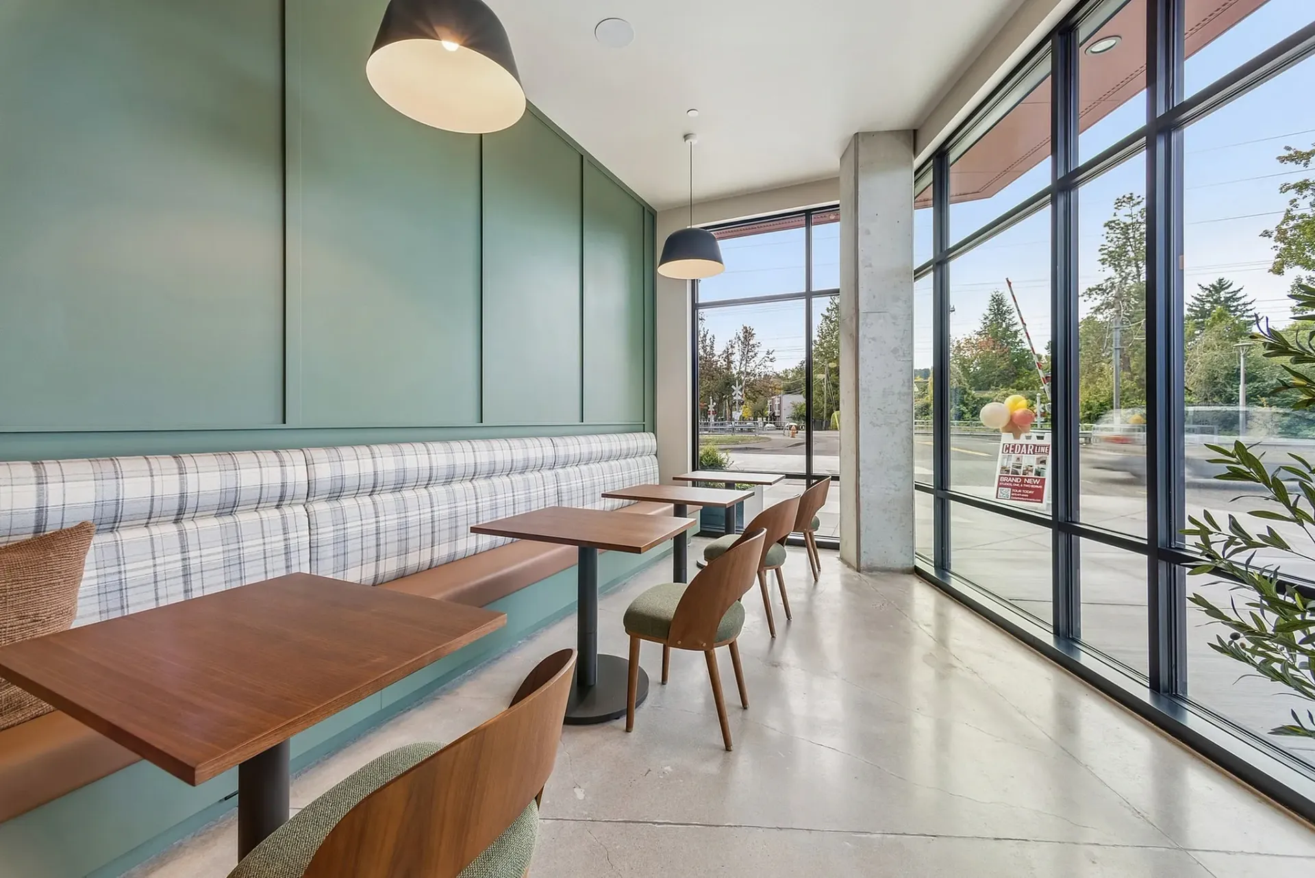 Modern dining area with banquette seating, tables, and chairs.