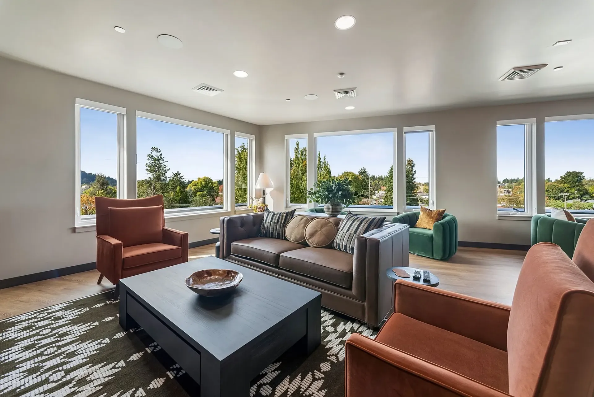 Luxurious resident lounge with comfortable seating and large windows offering scenic views.