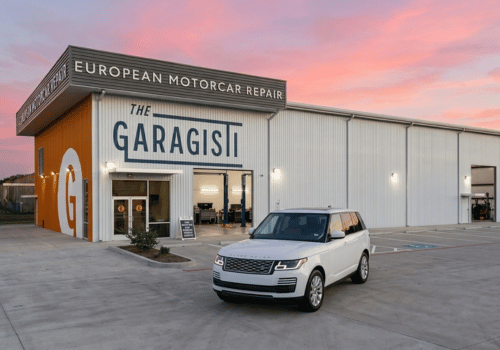 Exterior view of The Garagisti European Motorcar Repair facility with a white Range Rover