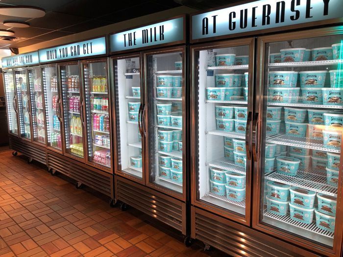 A row of ice cream coolers with the words at cueros written on them