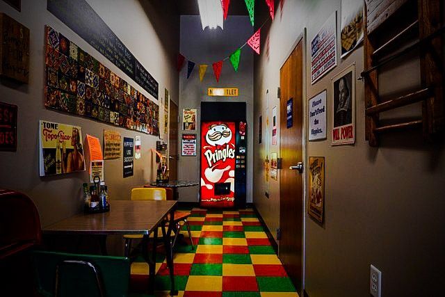 There is a pringles vending machine in the hallway.