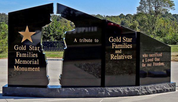 Gold Star Families memorial monument with engraved tribute panels and star emblem, outdoors on a stone base
