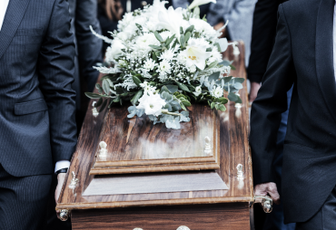 Funeral casket with white flowers