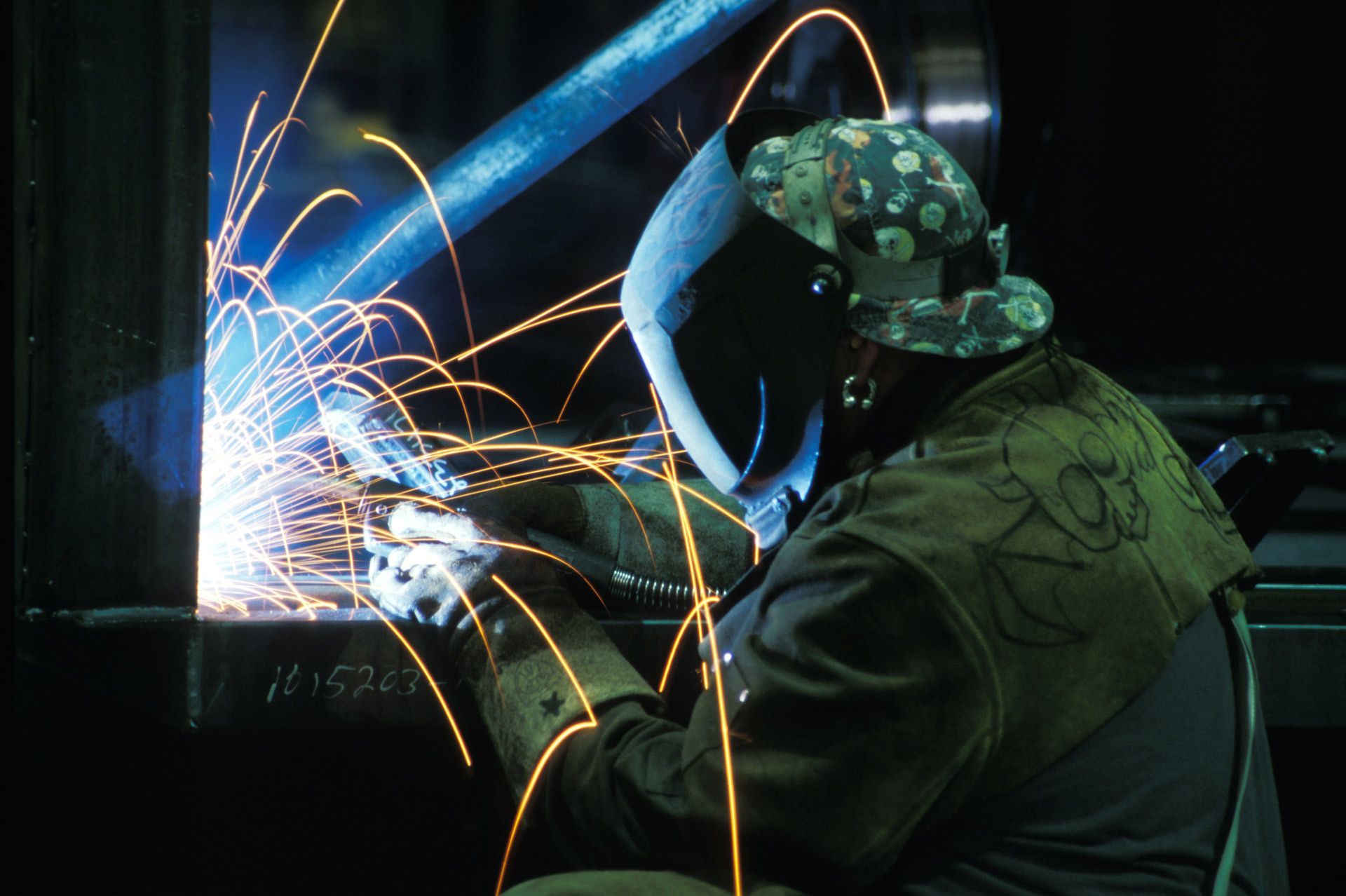 A skilled man engaged in welding, with sparks flying