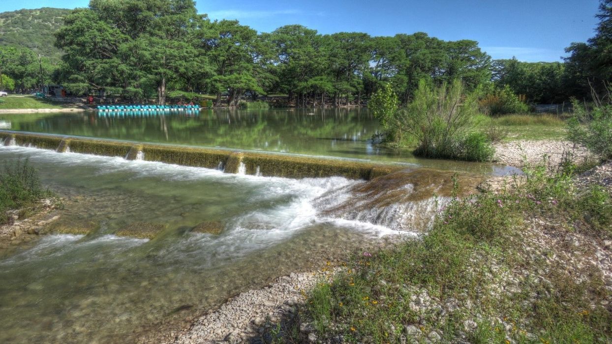 There is a small waterfall in the middle of the river.