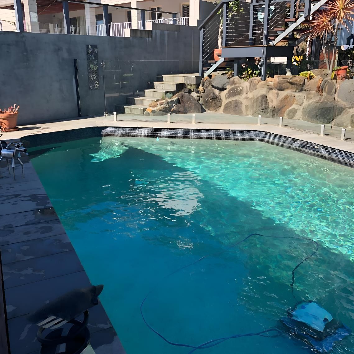 A Large Swimming Pool With A Robotic Vacuum Cleaner In It — Aqua Duck Pool Care In Landsborough, QLD