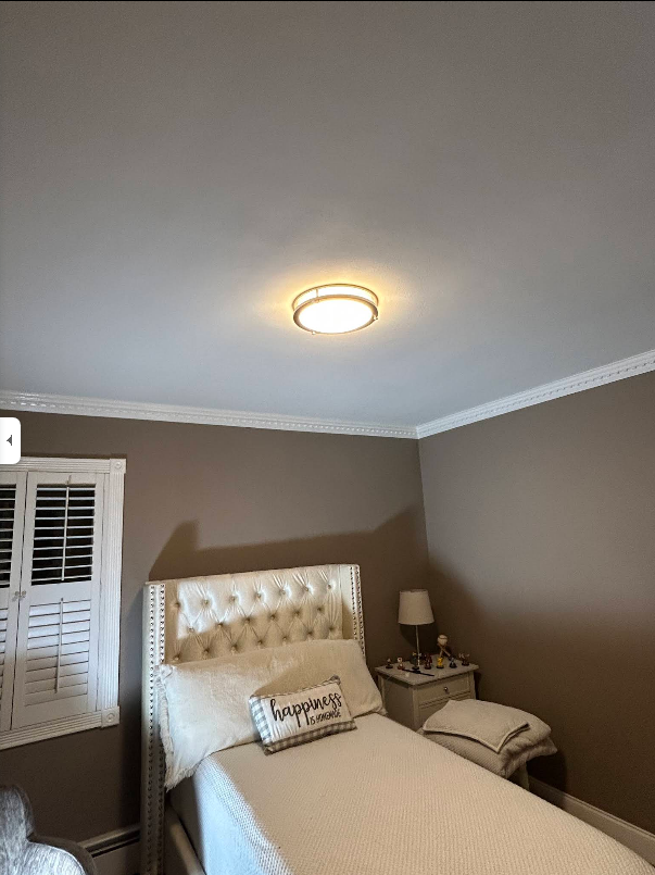 Bedroom with a bed, nightstand, and window with shutters. The walls are brown.